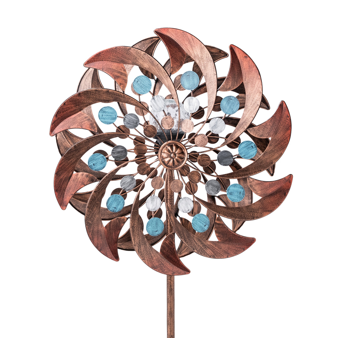A copper color decorative Metallic Kinetic Floral Windmill Spinner with a Solar LED Light and sparkling blue crystals.