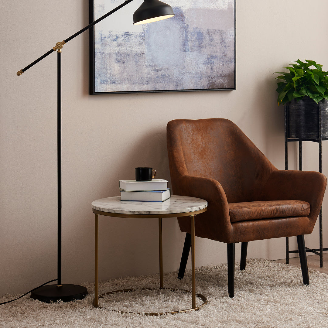 Modern brown accent chair with side table and black lamp.