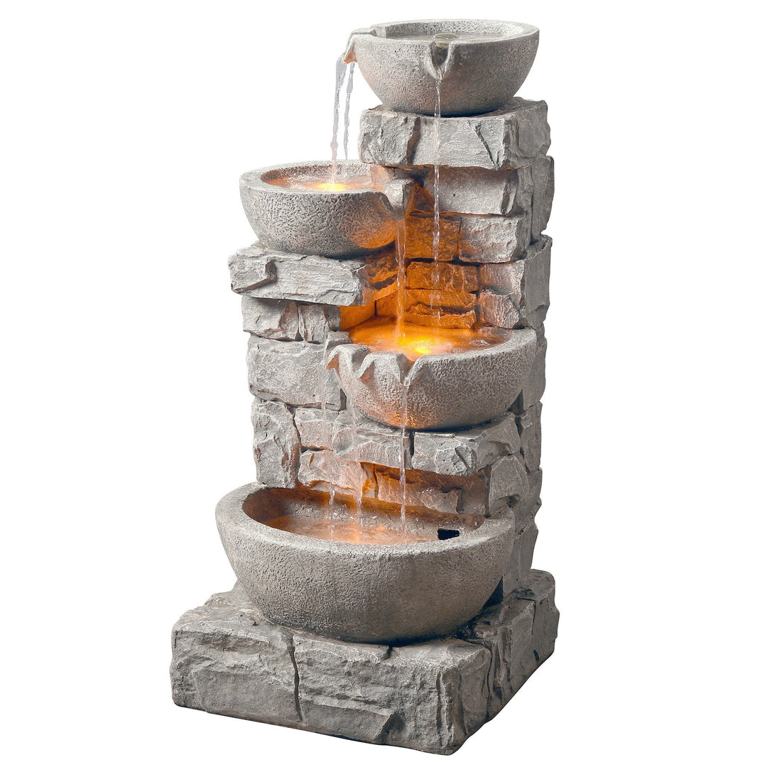 A faux rock 4-tier water fountain with led lights below the bottom 3 tiers.