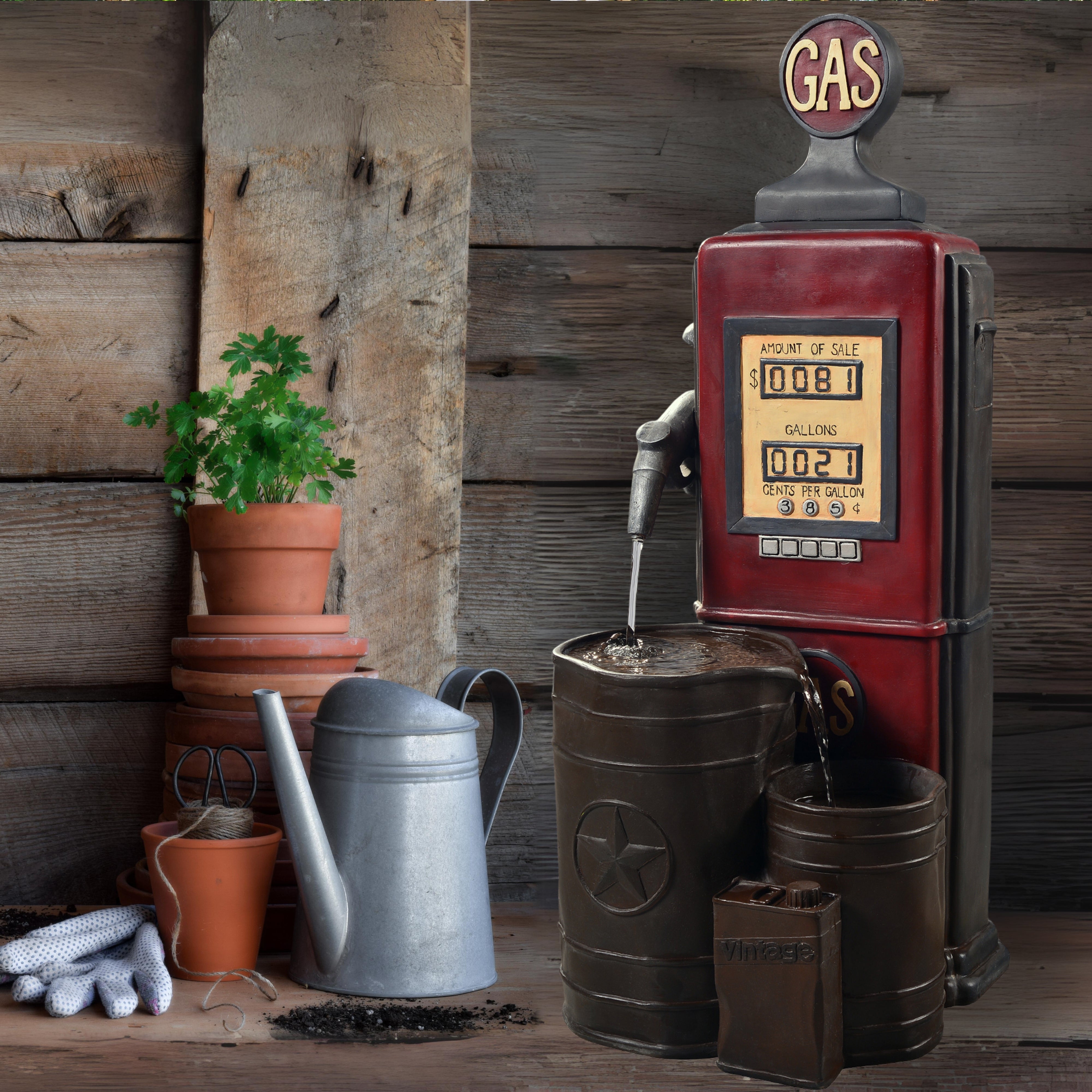 A vintage gas pump outdoor water fountain, plants and garden tools on a wooden floor