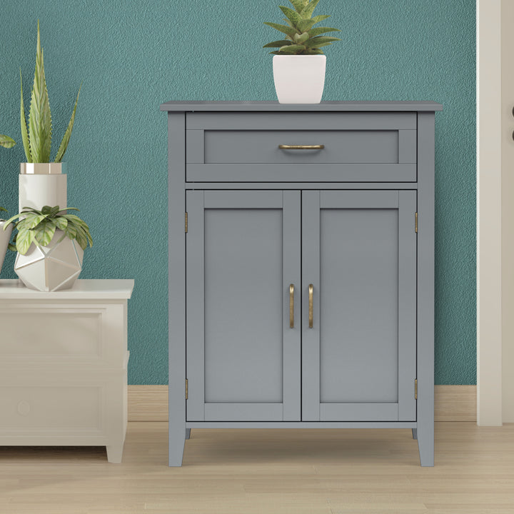 Gray cabinet in a living room with plants.