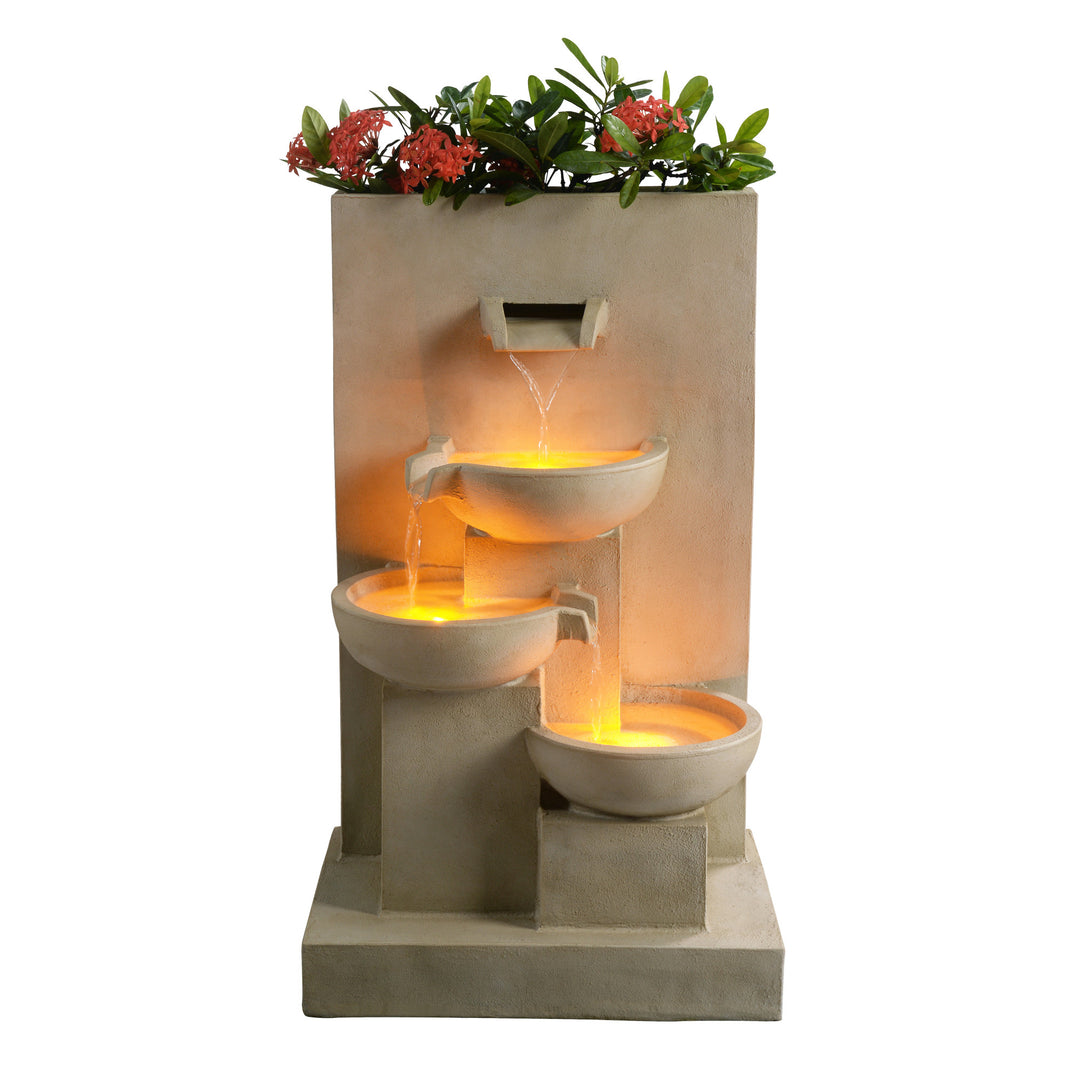 Illuminated multi-tiered garden water fountain with plants in a sandy color]