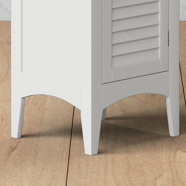 Closeup of the decorative legs on a tall white linen cabinet