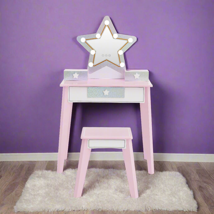 a star shaped vanity in pink and glittery silver with led lights is shown in a girls bedroom