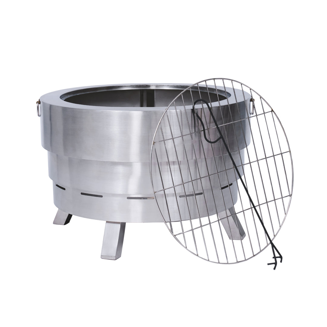 A round stainless steel fire pit with a removable grill grate and a hook. The fire pit stands on four sturdy legs.