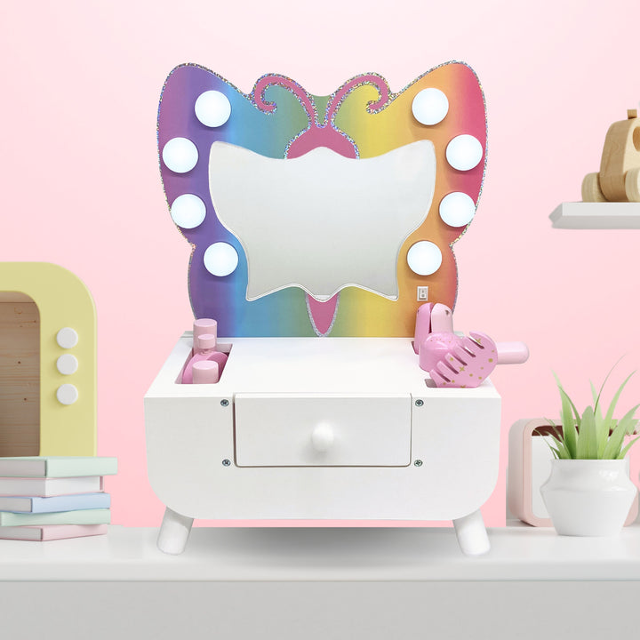 Butterfly vanity with makeup sitting on a child's desk.