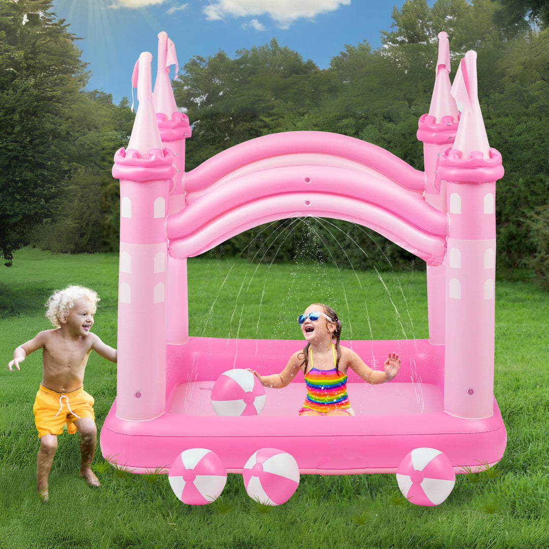 Children playing with a Teamson Kids - Water Fun Castle Inflatable Kiddie Pool on a sunny day.