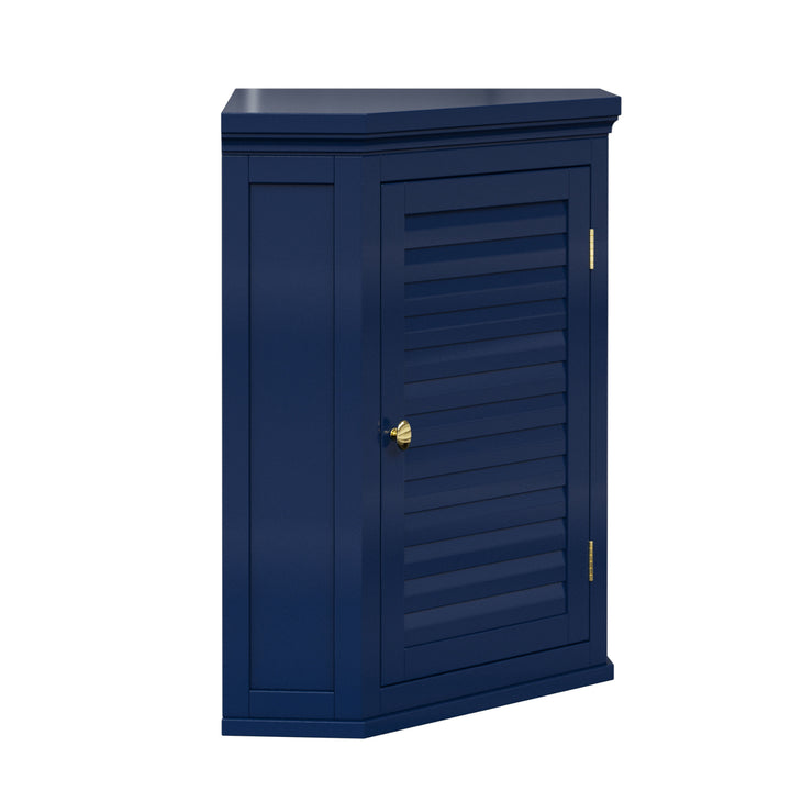 Side view of a navy blue corner wall cabinet with a faux louvered door and gold hardware.