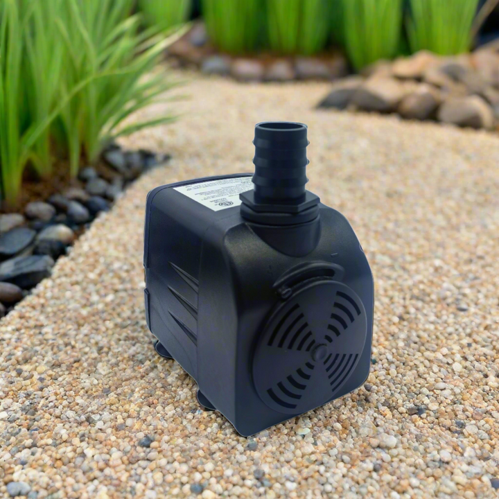 pump is shown on small pebbles next to a landscaped garden pond