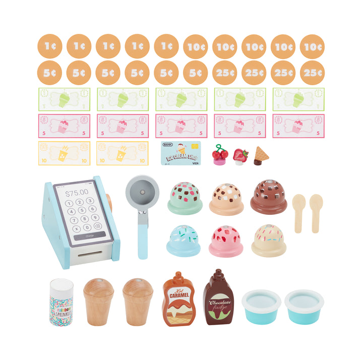 A photo of all of the accessories to the ice cream cart: 20 play coins, 12 play dollars, a play credit card, three magnetic pretend topping, a small cash register, an ice cream scoop, six colorful magnetic scoops of ice cream, t2 spoons, a container of sprinkles, two magnetic cones, two bottles of ice cream topping and two magnetic bowls.