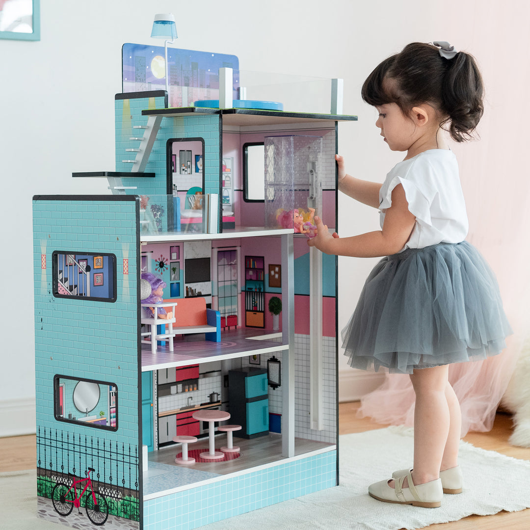 A little girl placing a doll in the clear, working elevator on the third floor.