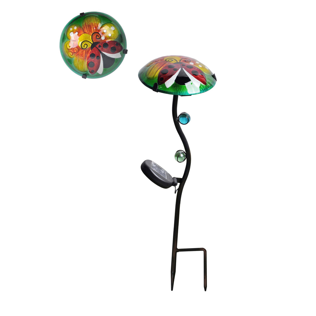 Decorative garden stake solar light with ladybug and flower designs on a green background.