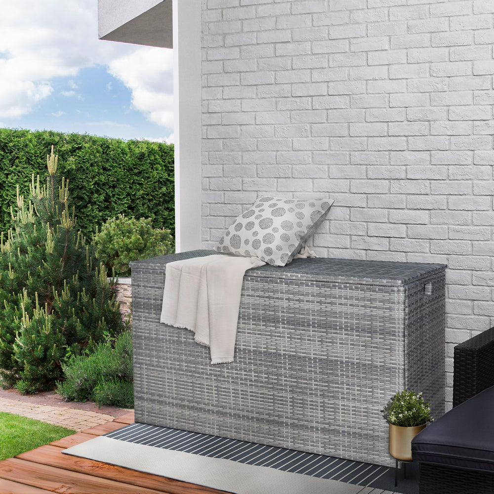 Teamson Home Gray PE Rattan 154-Gallon Outdoor Deck Boxset up against a house outdoors