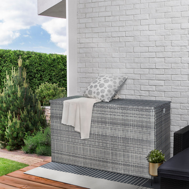 Teamson Home Gray PE Rattan 154-Gallon Outdoor Deck Boxset up against a house outdoors