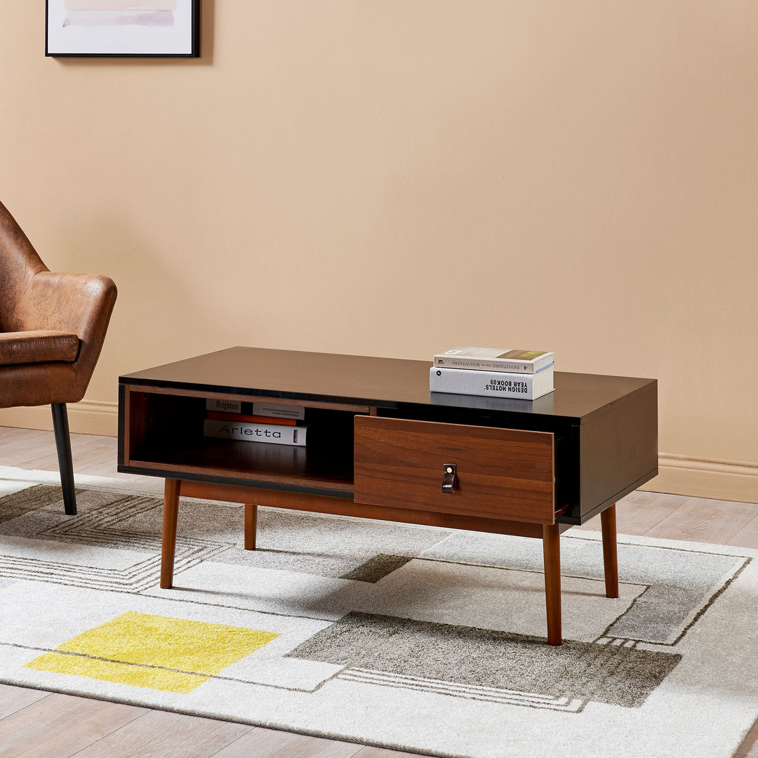 A Teamson Home Reno Coffee Table with Storage Drawer in a living room with a brown leather chair.