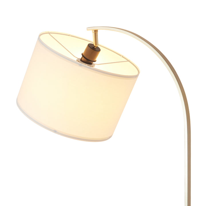 A Teamson Home Danna Floor Lamp with Marble Base and Built-In Table, White with the light on