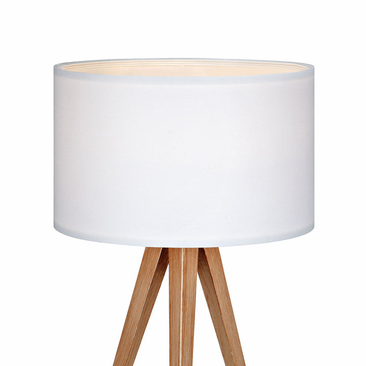 Close-up of a Teamson Home Romanza 20" Natural Wood Tripod Table Lamp with White Drum Shade
