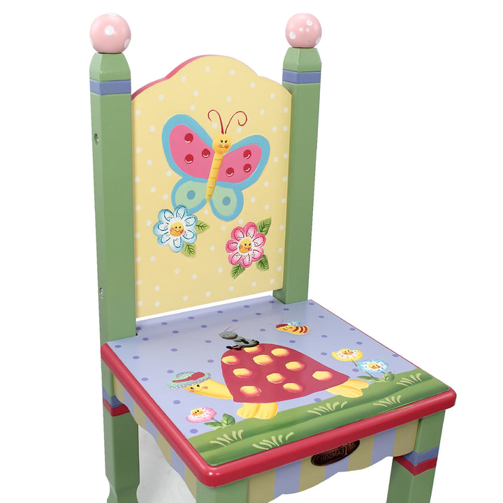 Closeup of the illustrations on a child's chair - butterfly, two flowers, turtle, worm, bee, and more flowers