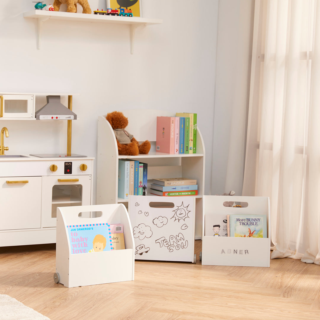 A playroom with the the portable bookcase set, a bookshelf with some books on it, and a play kitchen.