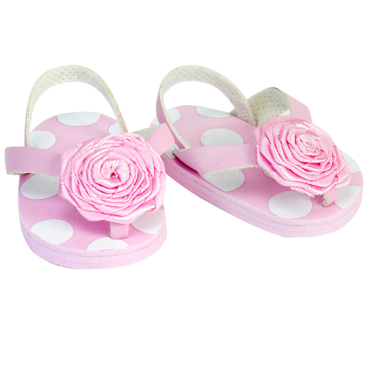 Close-up of pink with white polka dots and rosettes flip flop sandals for 15" baby dolls