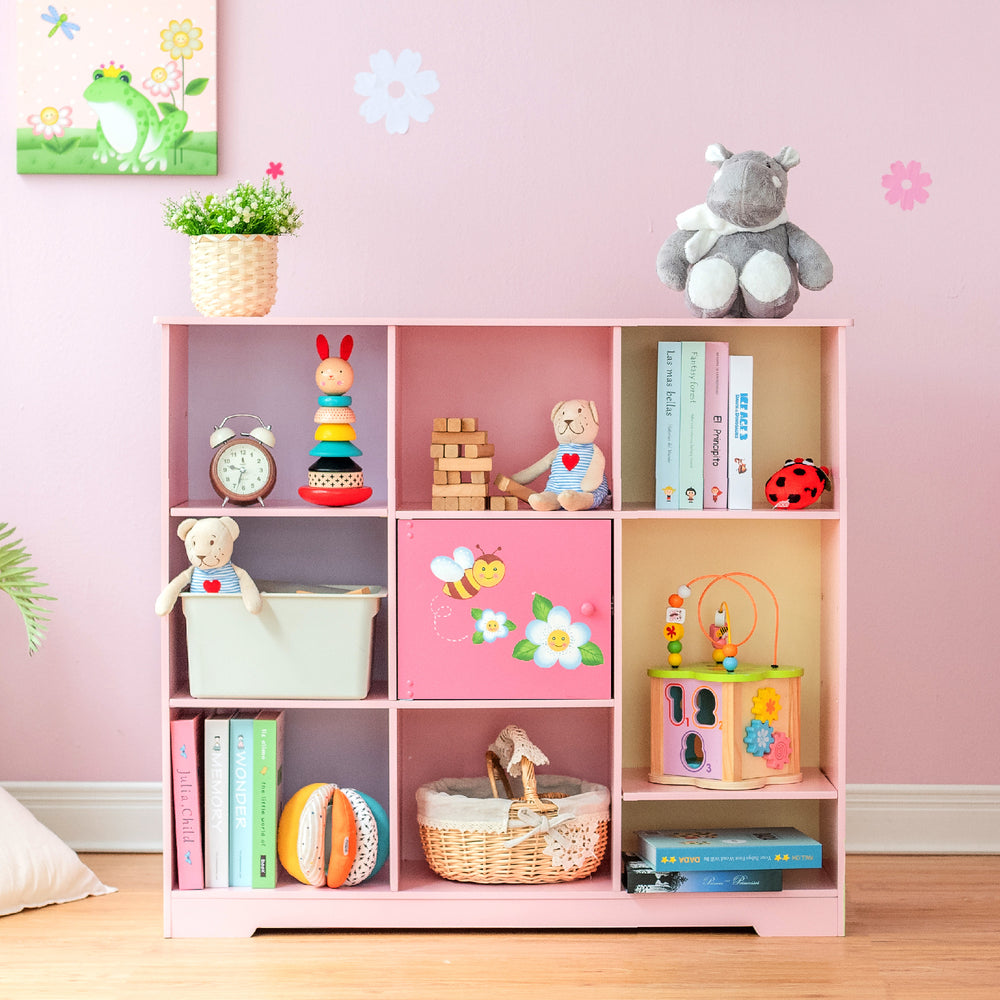 A Fantasy Fields Kids Painted Wooden Magic Garden Adjustable Cube Bookshelf, Pink with toys, a stuffed animal, and durable construction.