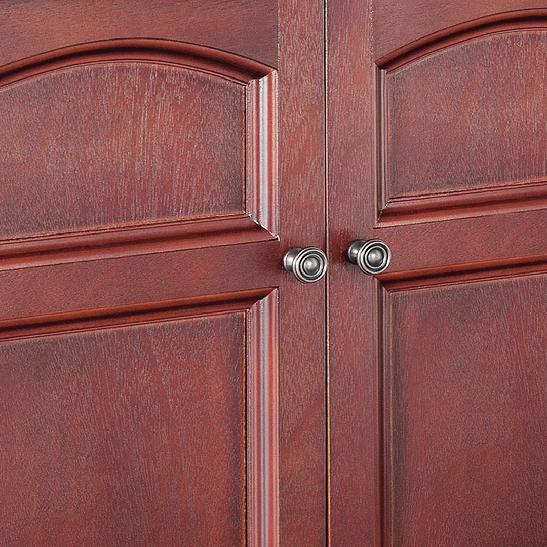 A close-up of a pair of round antiqued brass pull knobs