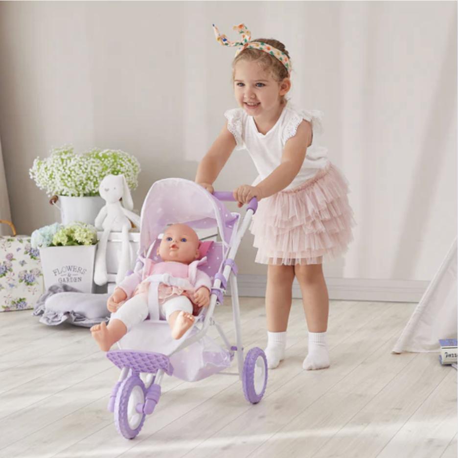 A young girl pushes her realistic purple baby doll stroller