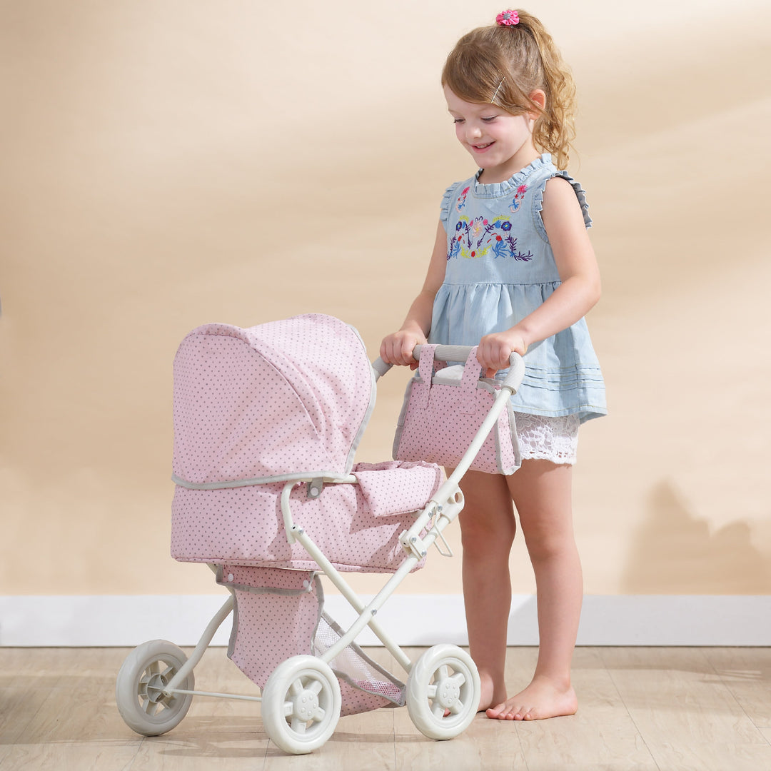 A little girl in a pink tutu is pushing a baby doll in a purple stroller