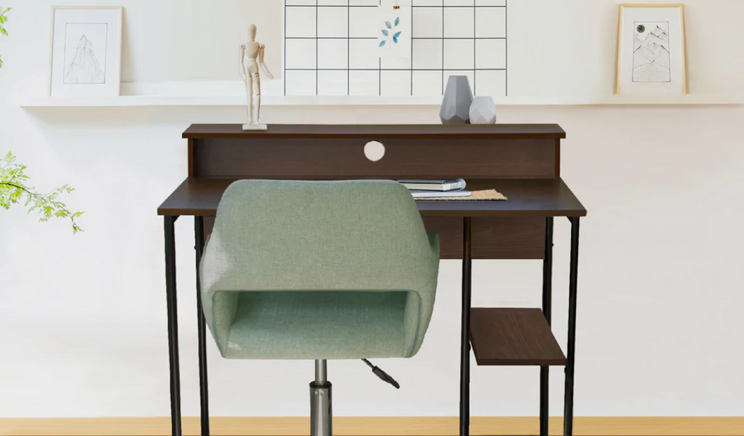 Green swivel desk chair sits in front of a small brown wooden Teamson desk.