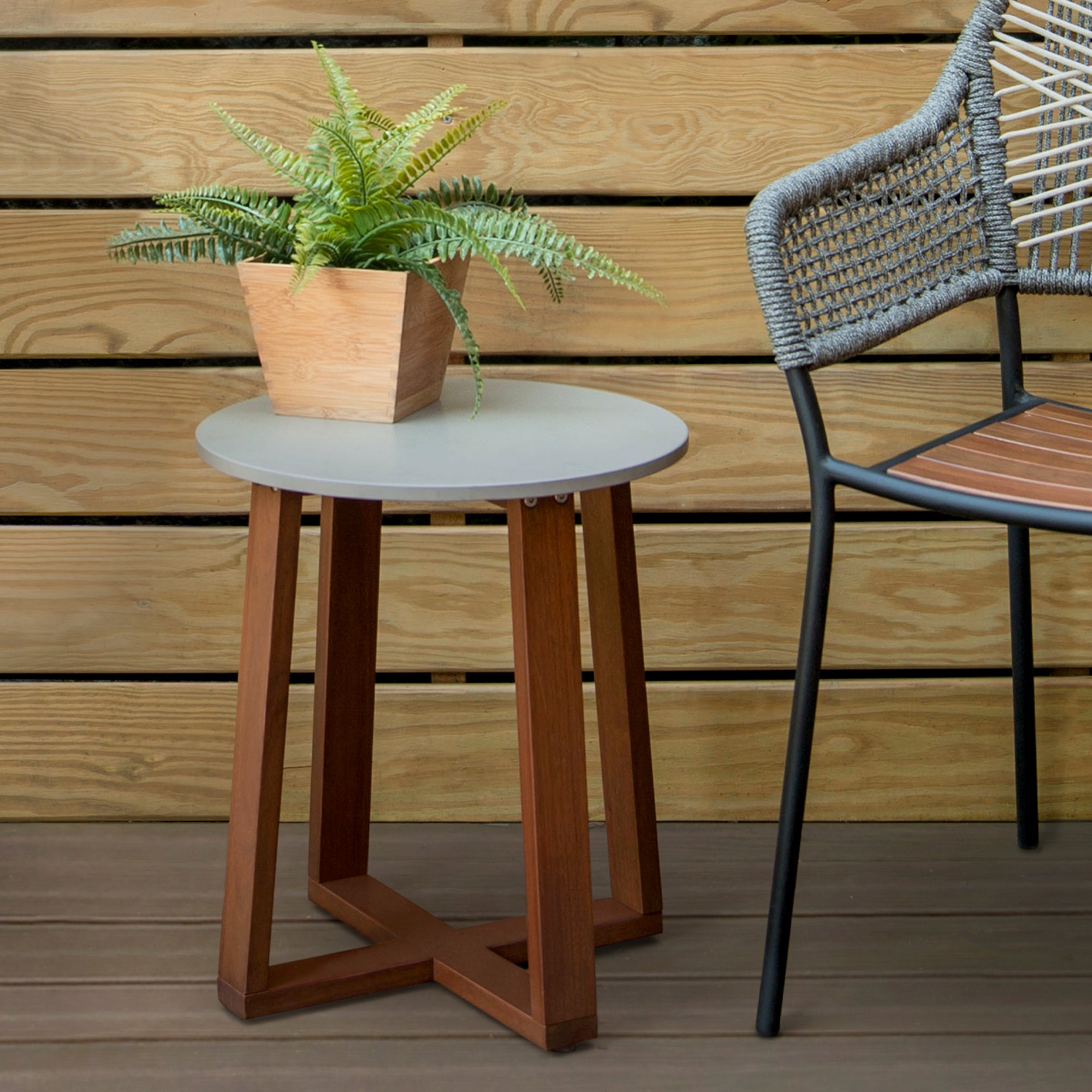 Solid Eucalyptus Wood Patio Side Table with Superstone Top is pictured outside.