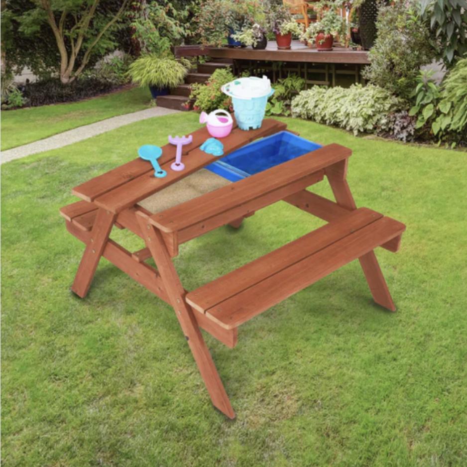 A cherry colored picnic table includes hidden sensory bins for multifunctional use.