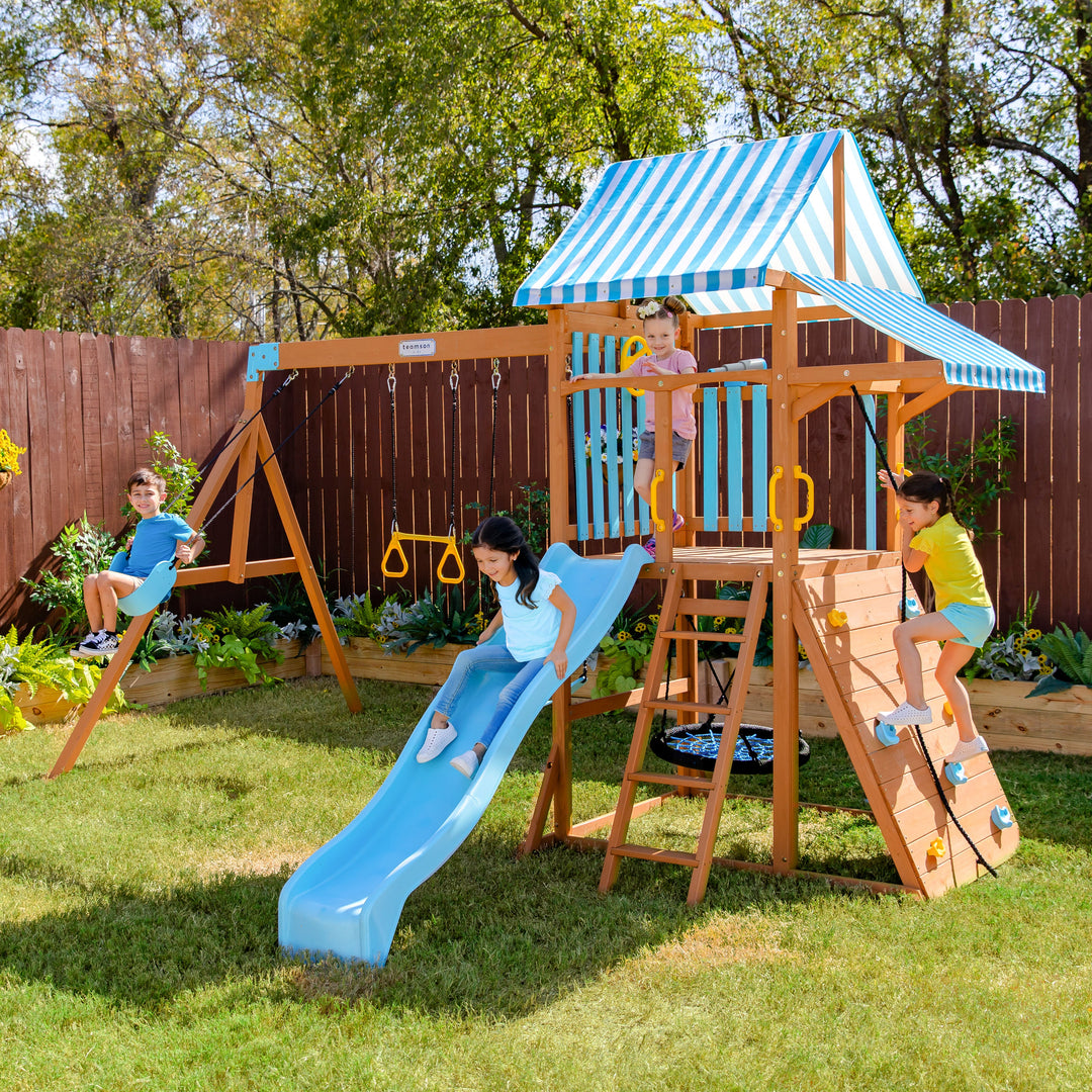 Two boys in a red inflatable pirate ship in a sunny garden