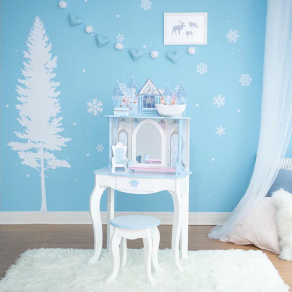 A blue, princess themed vanity sits in a winter bedroom