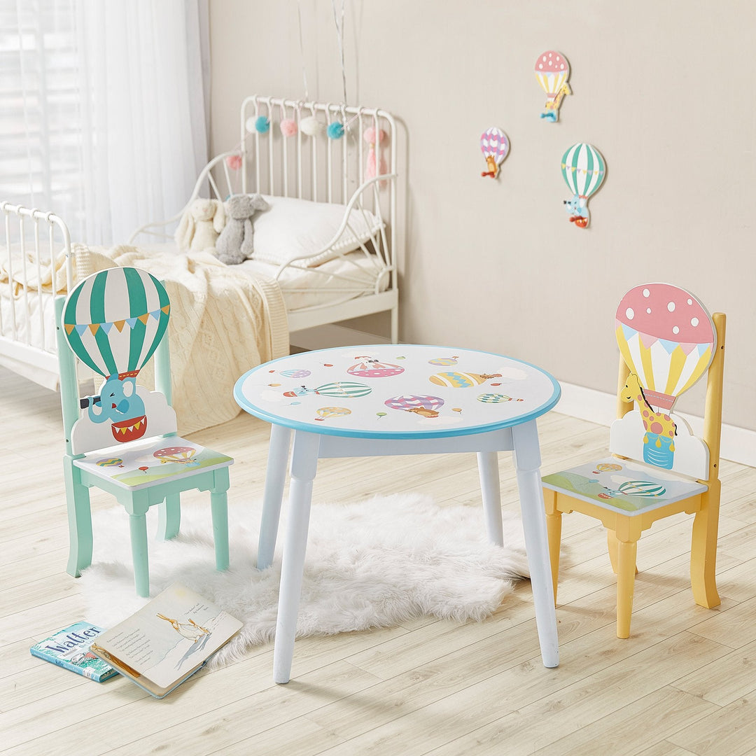 A room featuring a hot air ballon theme shows a table with matching chair and room decor of the same design,