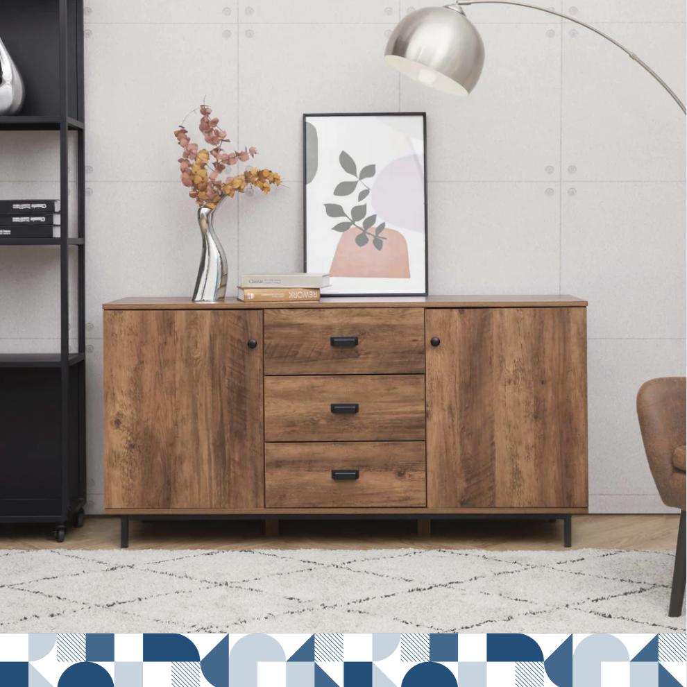 a walnut finished sideboard with black hardware against a gray wall with a silver arc lamp