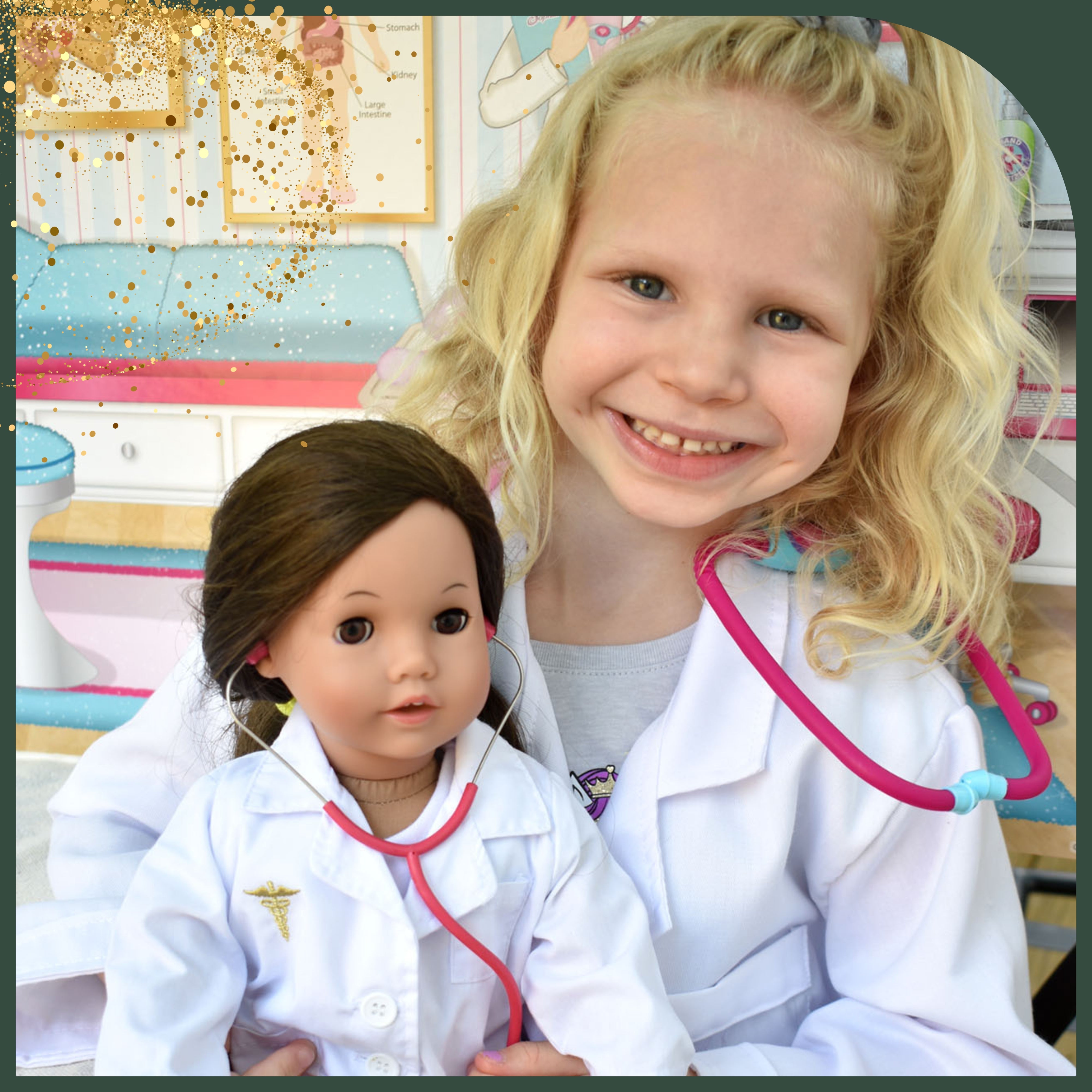 a smiling young girl and her doll are dressed as matching doctors with lab coats and stethoscopes 