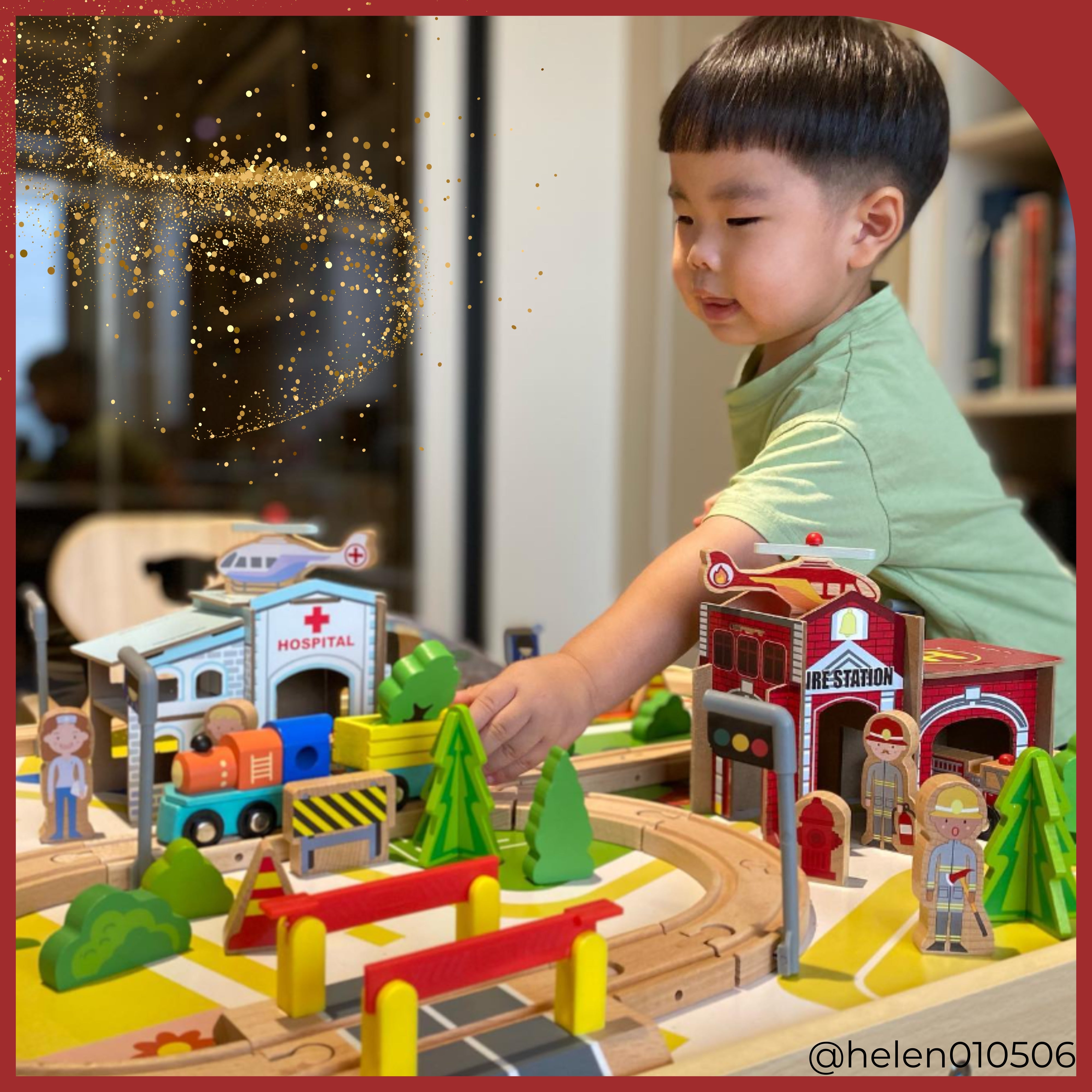 a young boy sets up the town and train tracks on his train table