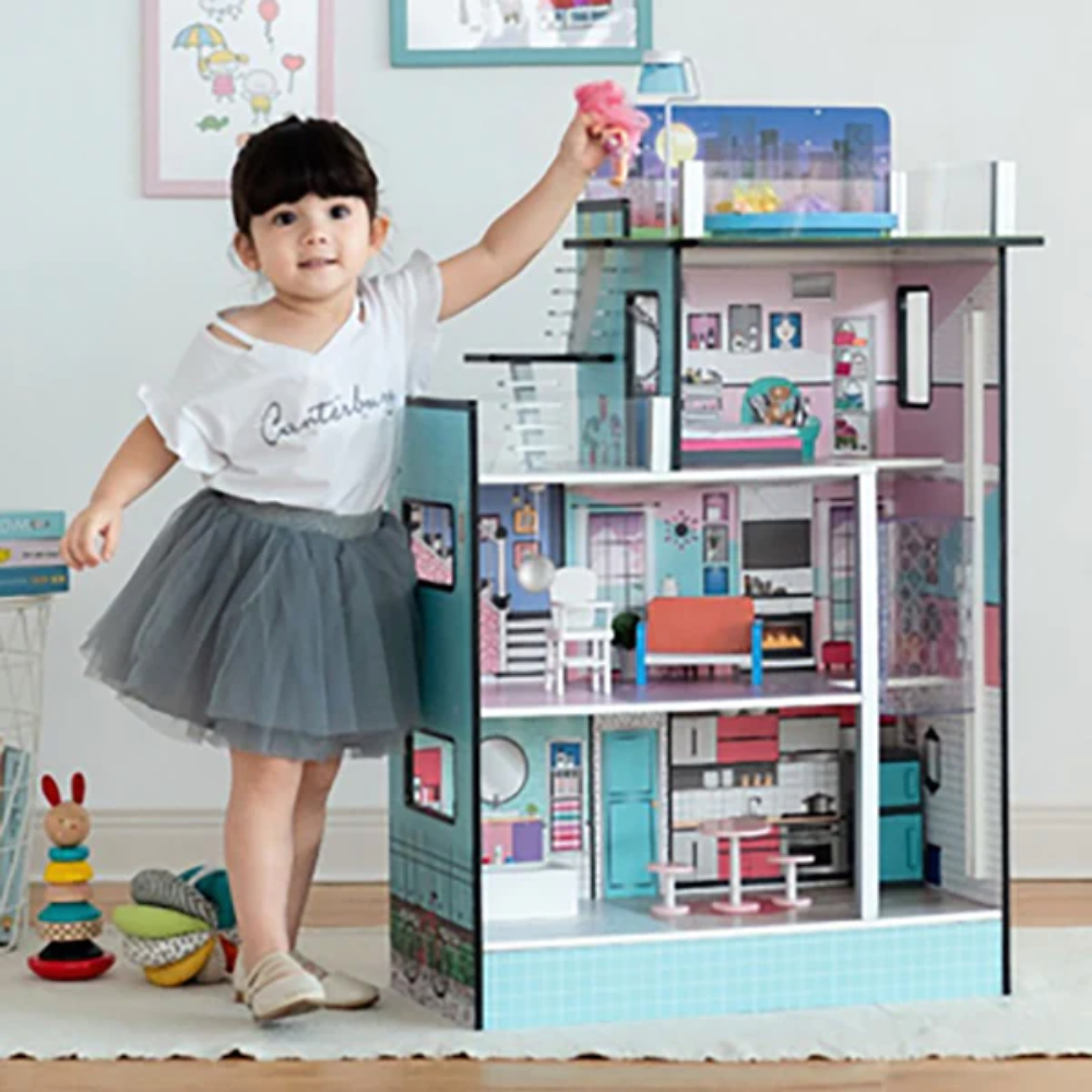 Child playing with a Teamson Dollhouse.