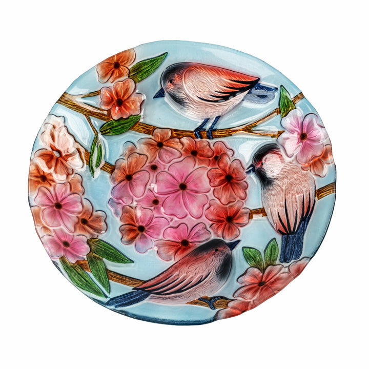 A 17.8" Robins & Blossoms Fusion Glass Birdbath with Metal Stand, Multicolored, with detailed flowers and bird illustrations.