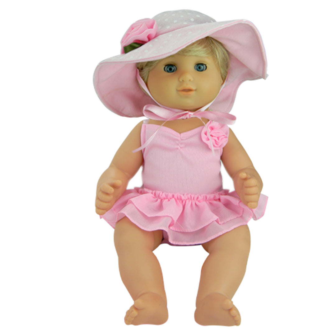 Baby doll dressed in pink swimsuit and sunhat
