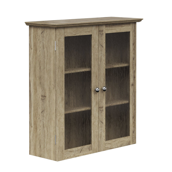 Side view of the front of a light oak finished wall cabinet with two glass-paneled doors.