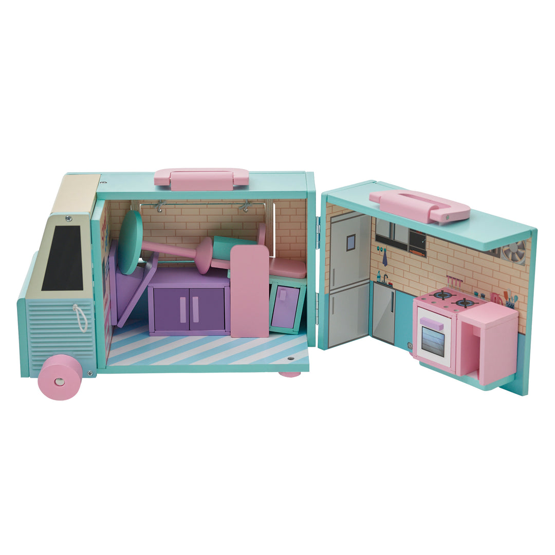 A blue and pink food truck opened with all of the accessories stacked inside:  a purple sandwich board, two pink chairs and a blue table, a pink stove, a blue sink, a purple cooler, and a pink counter.
