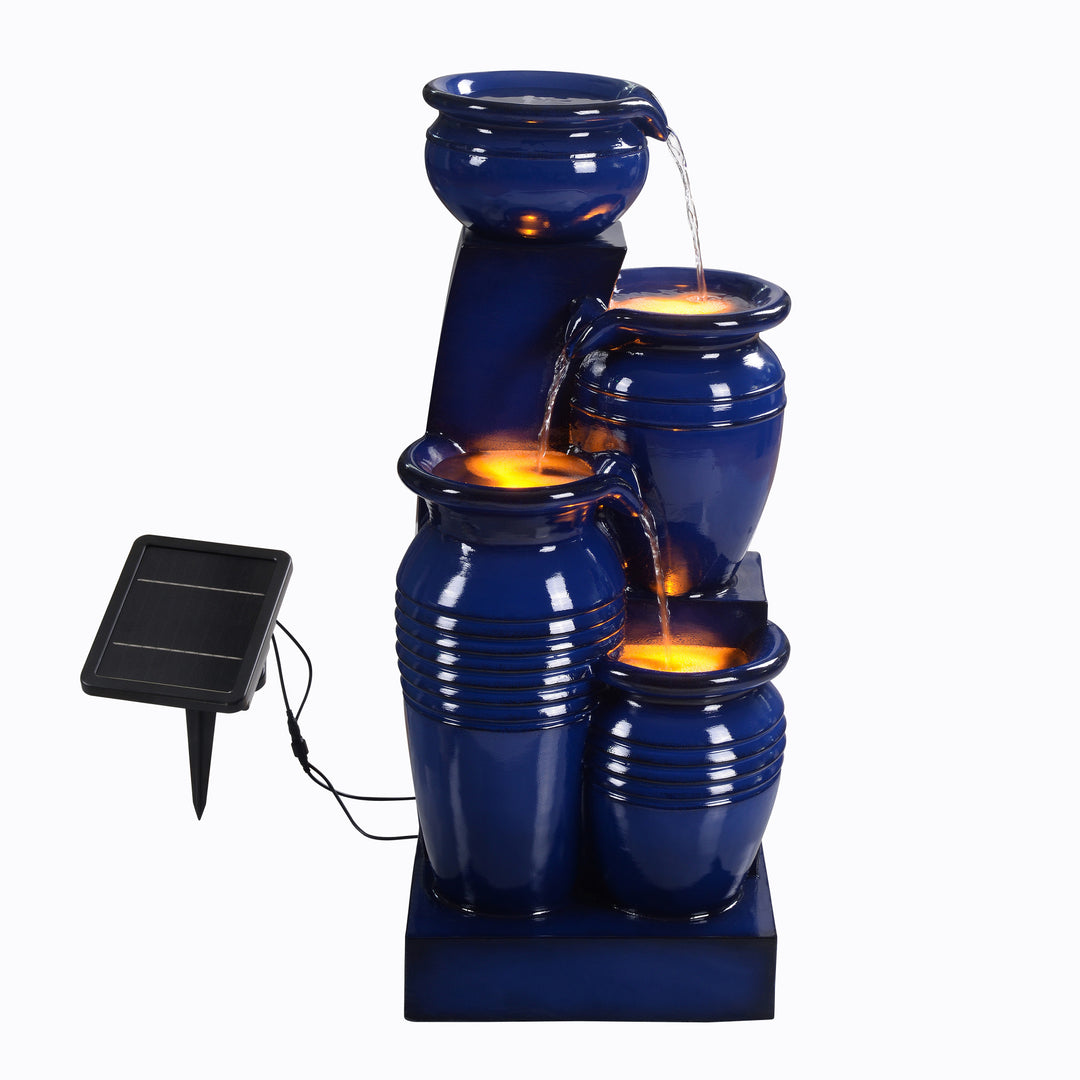 Teamson Home 28.74" Navy Blue 4-Tier Outdoor Solar Water Fountain with LED Lights on, water flowing, and a solar panel