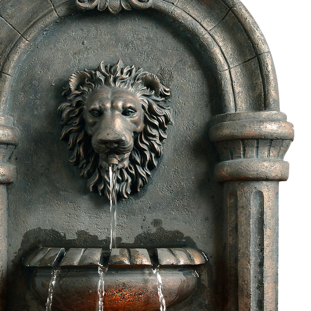 Teamson Home Outdoor Tiered Lion Head Wall Water Fountain with water flowing from its mouth into a basin.
