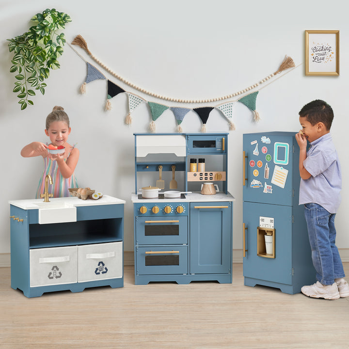 Two children playing with a Teamson Kids - Little Chef Atlanta Large Modular Play Kitchen, Stone Blue/Gold.