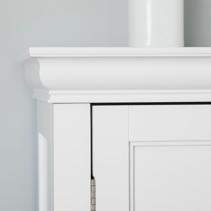 A top of a white floor cabinet with crown molding
