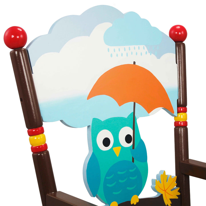 Close-up of the back of the rocking chair with the blue owl holding the orange umbrella under a raincloud..