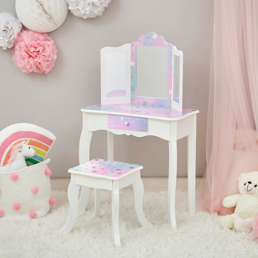 A pink and white FANTASY FIELDS - GISELE STARRY SKY PRINT vanity set with a mirror and teddy bears.