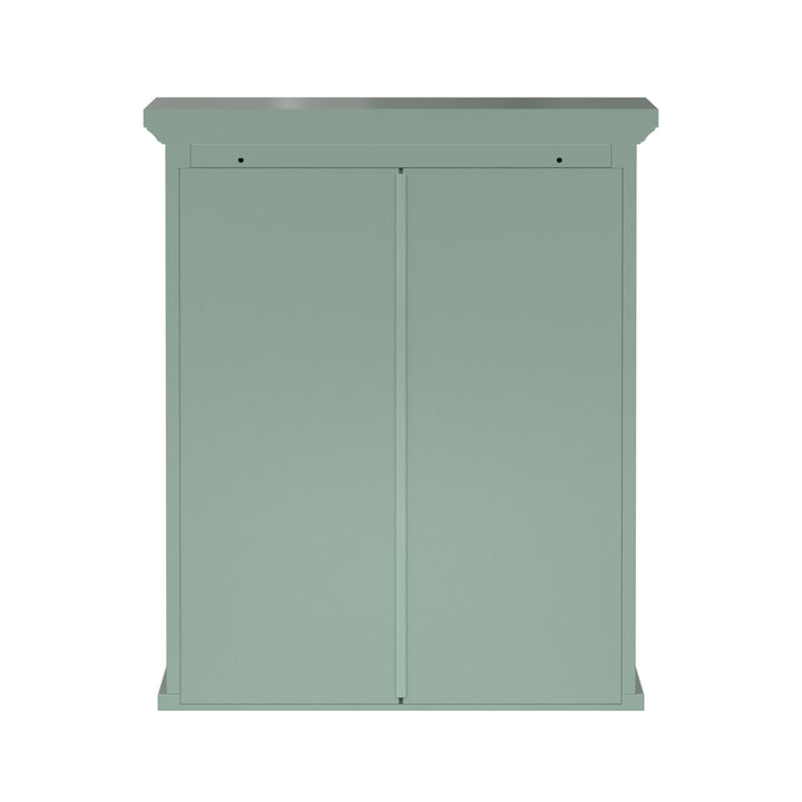Back view of a sage green wall cabinet with chrome knobs and two faux louvered doors.