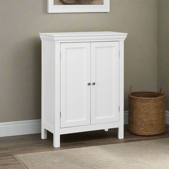 A white floor cabinet with double doors against a tan wall